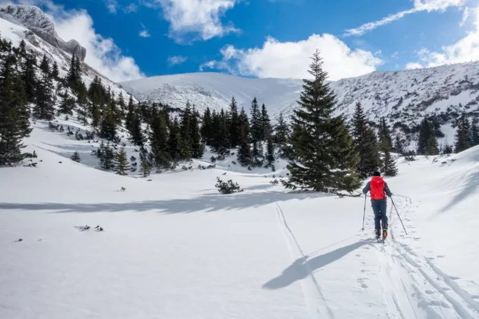 Skitourengeher am Schneeberg mit Wurzengraben im Hintergrund